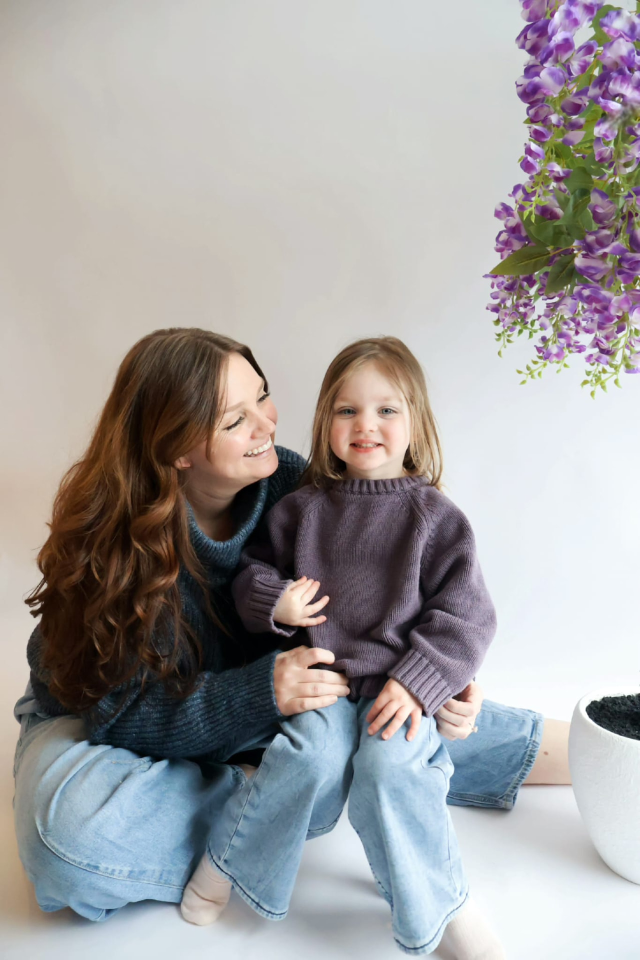 Mother and daughter in soft knit sweaters during a seasonal session