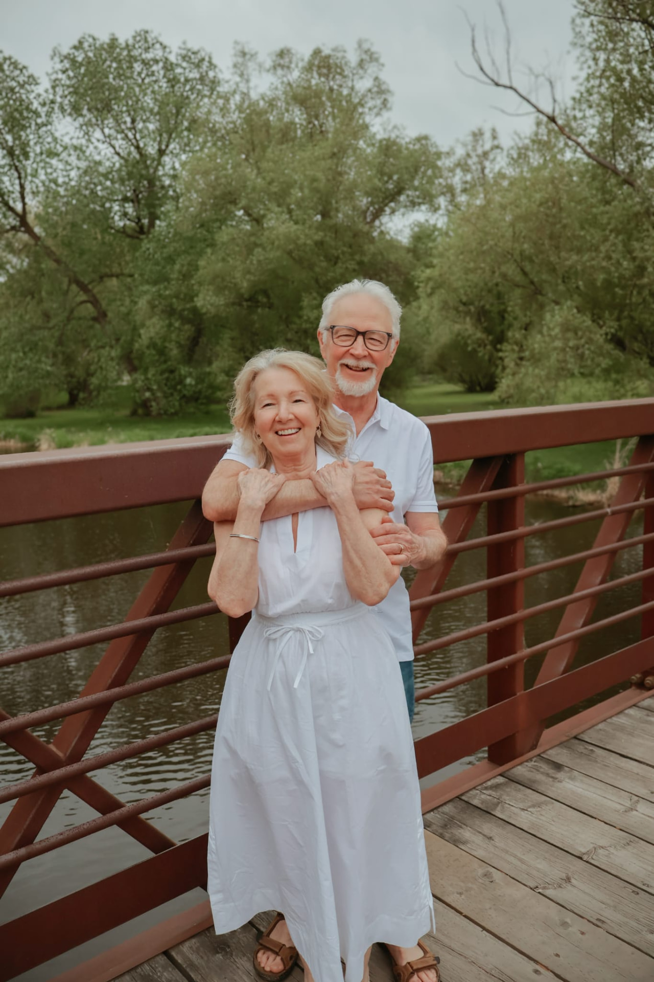 Couple photographed outdoors on a bridge during a late summer session